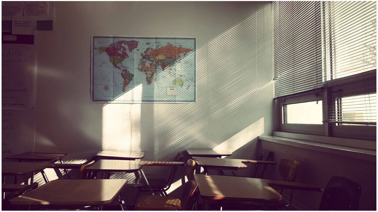 Des stores baissés dans une salle de classe pour faire barrage au soleil.