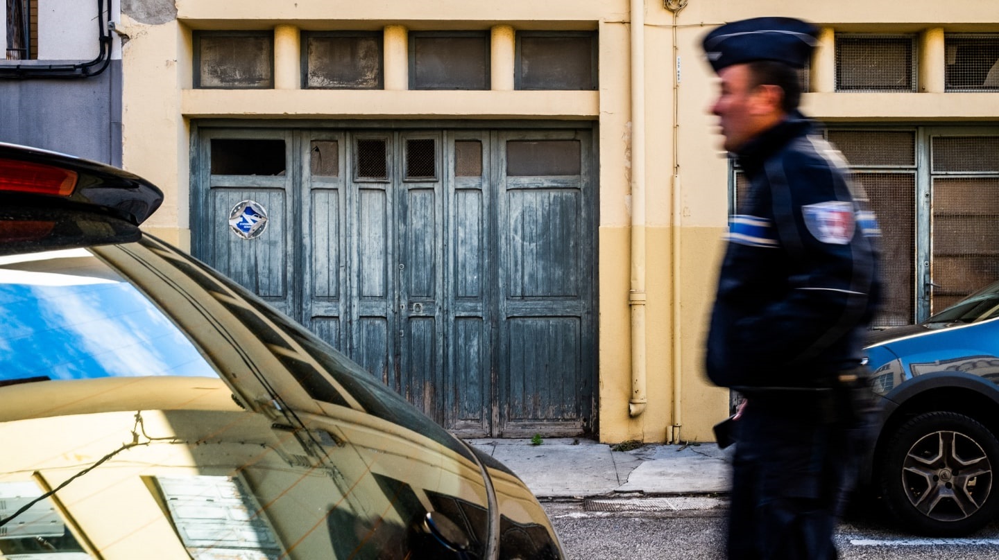 Un policier de profil se déplace dans une rue